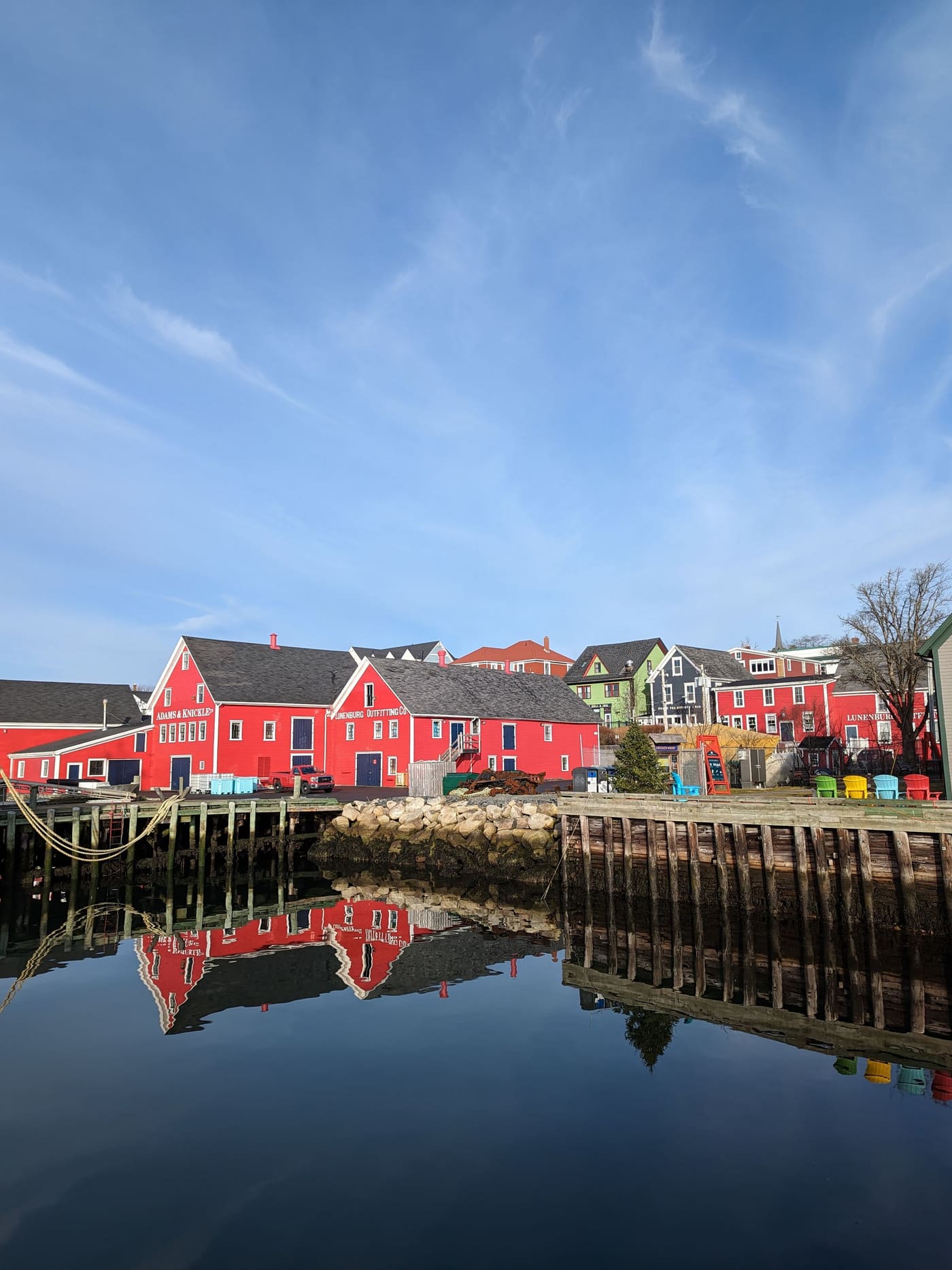 Red wooden waterfront buildings and painted houses in Lunenburg, Nova Scotia
