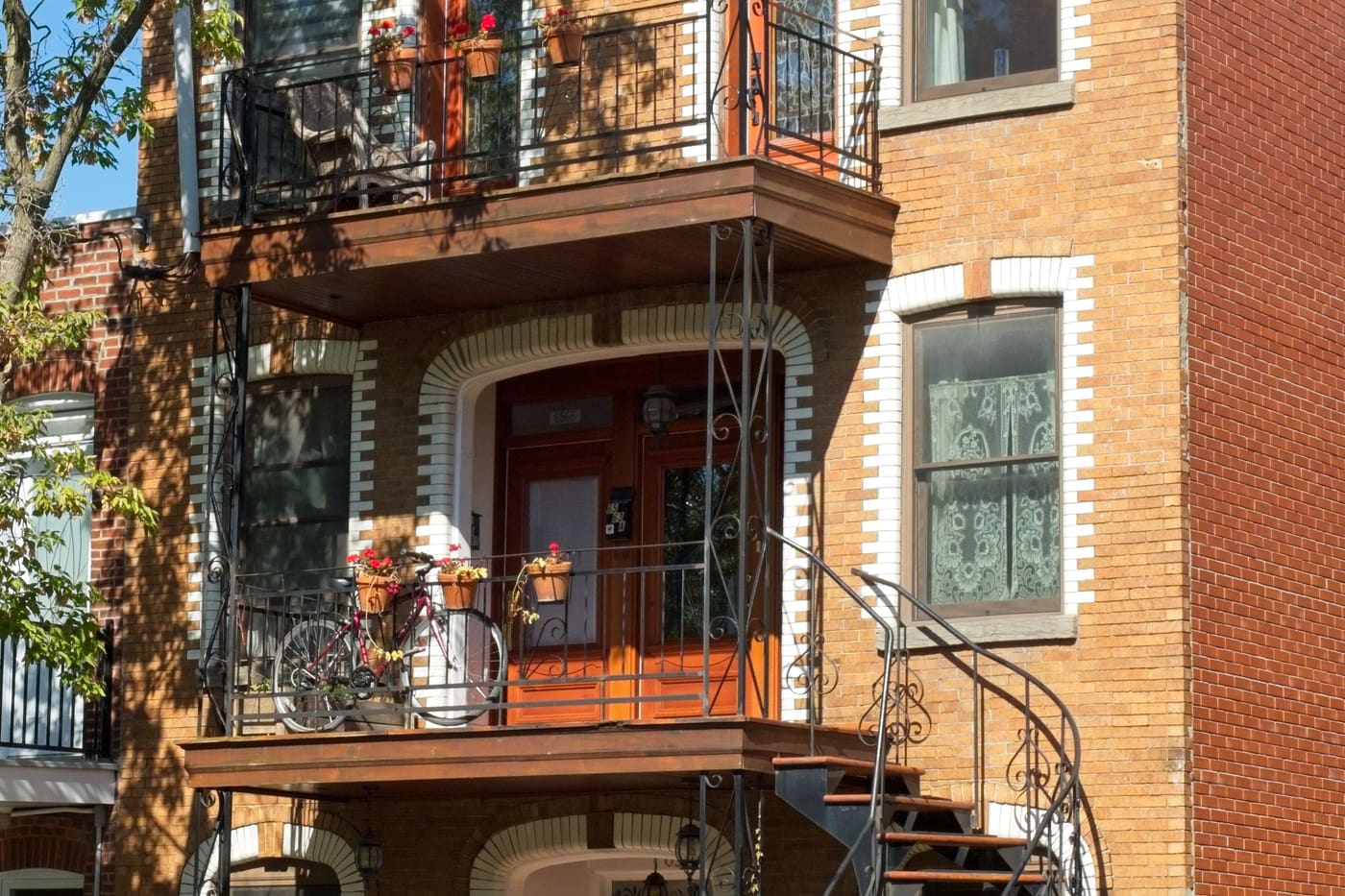 A brick walk-up with outside staircases and balconies