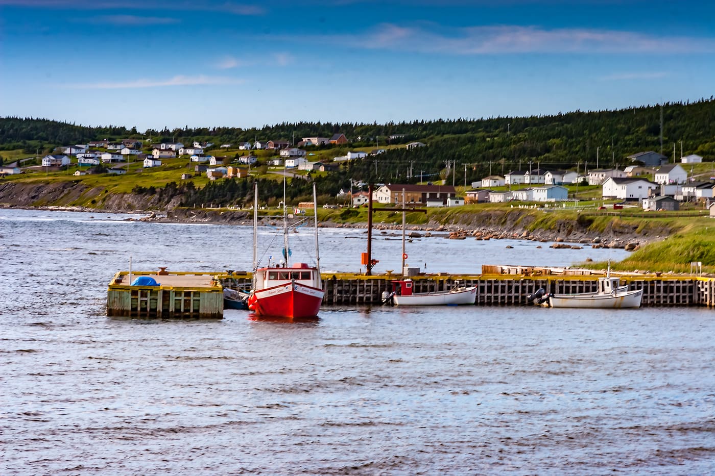 Fishing boats at a wharf below a hillside of houses, North Sydney, Cape Breton