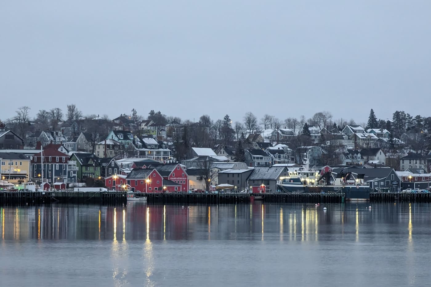 Houses climbing the hill above Lunenburg harbour on a winter evening